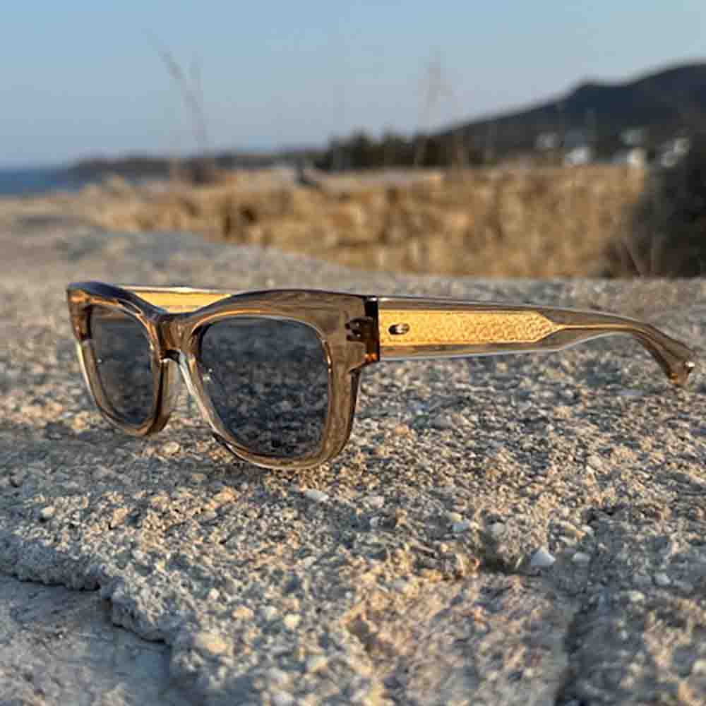 garrett leight sunglasses with brown transparent frame with blue lenses