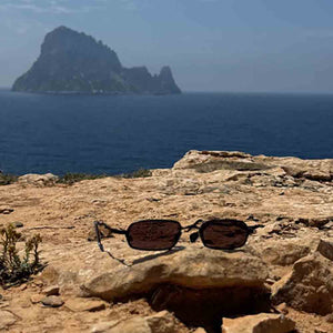 kuboraum sunglasses in Ibiza in front of es vedra'